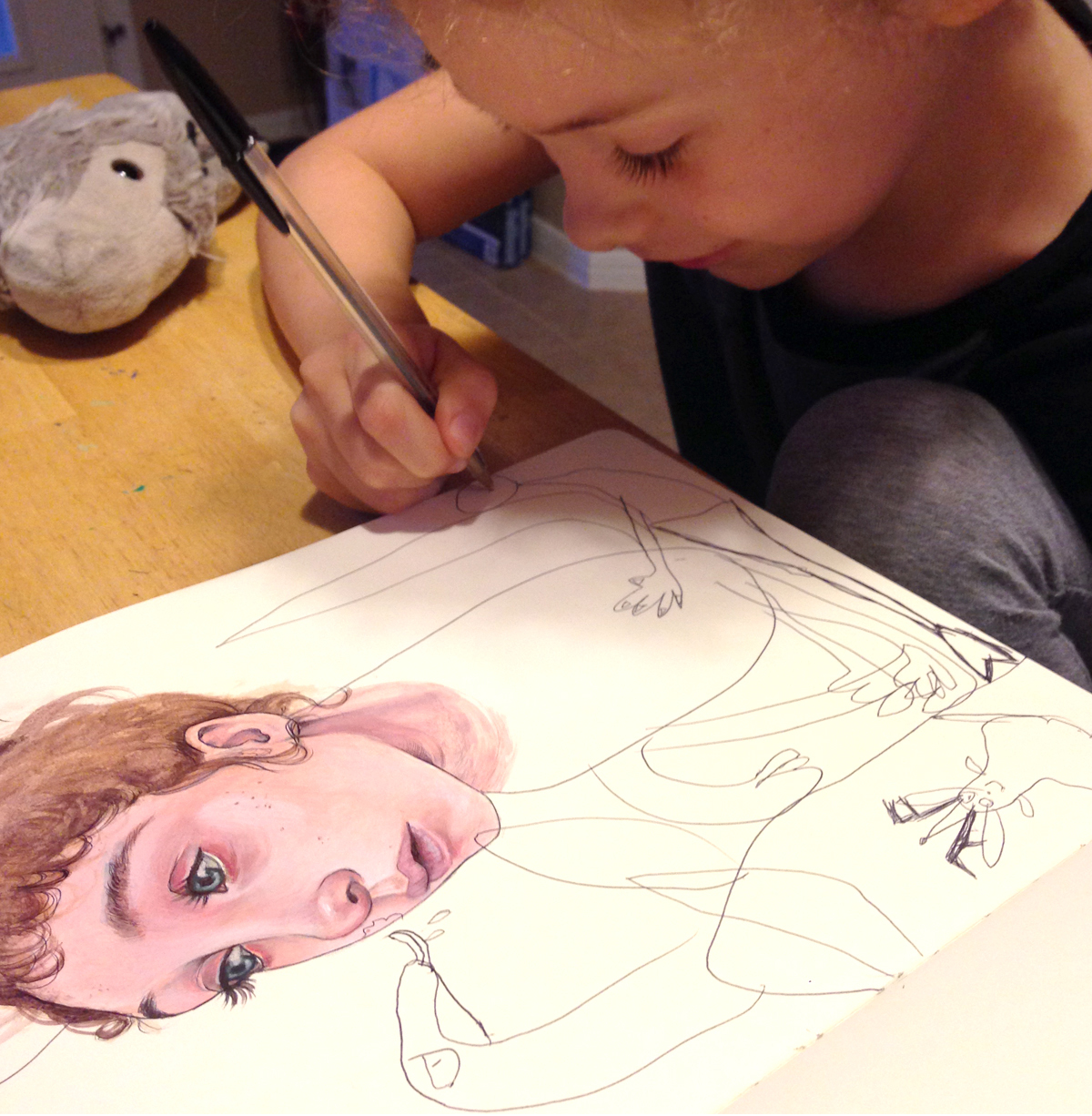 Mica's daugher, Myla Hendricks, adding finishing touches to Mica's illustration.