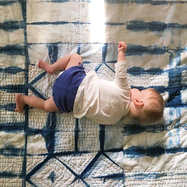 Baby Etta with her quilt, a work in progress. 