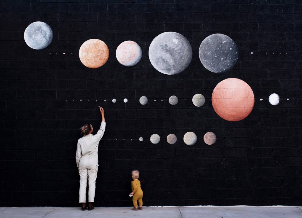 Stella and Wyeth, making last touches on '48 Moons', a mural in downtown Denver